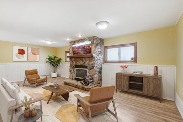 1228 N Lake Shore Dr, Round Lake Beach, IL 60073 - living room featuring a wainscoted wall, a fireplace, and wood finished floors