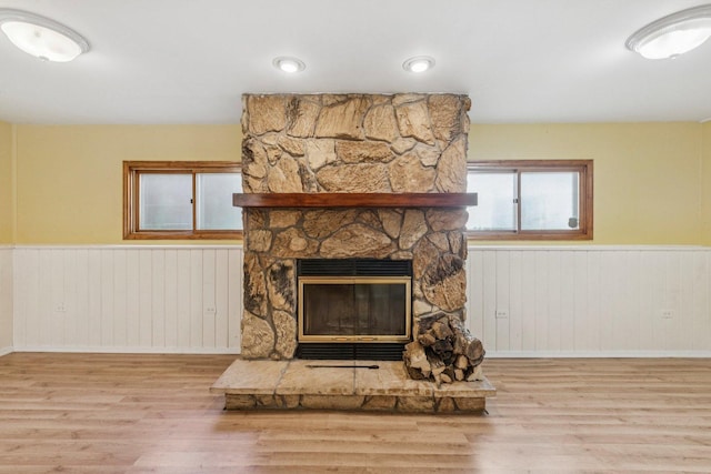 1228 N Lake Shore Dr, Round Lake Beach, IL 60073 - detailed view of wood finished floors, a wainscoted wall, a stone fireplace, and wooden walls