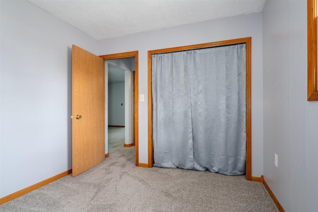 112 NW Adams St N, Hopedale, IL 61747 - unfurnished bedroom featuring carpet floors, a closet, and a textured ceiling
