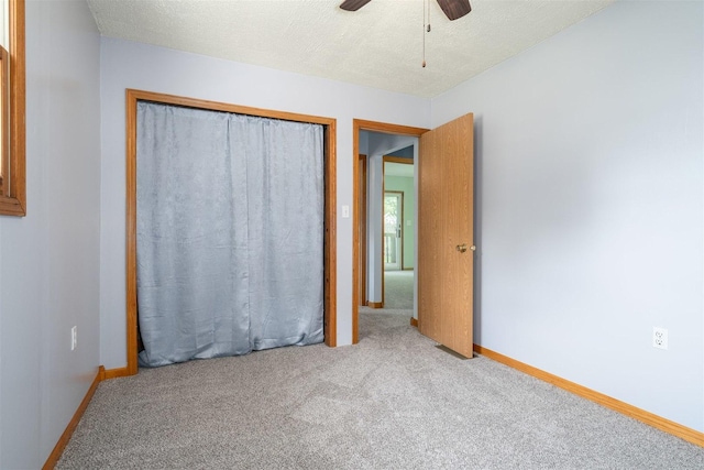 112 NW Adams St N, Hopedale, IL 61747 - unfurnished bedroom with carpet floors, a closet, a ceiling fan, and a textured ceiling