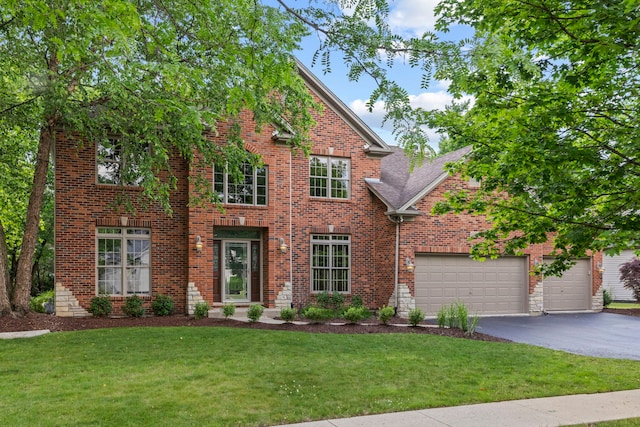 609 Spruce Ct, Oswego, IL 60543 - view of front facade with driveway, brick siding, a front yard, and an attached garage