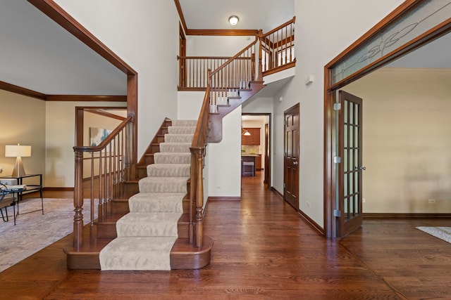 609 Spruce Ct, Oswego, IL 60543 - stairway featuring wood finished floors, crown molding, and a high ceiling