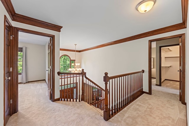 609 Spruce Ct, Oswego, IL 60543 - hallway featuring carpet, an upstairs landing, crown molding, and a chandelier