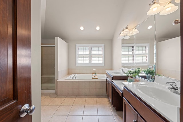 609 Spruce Ct, Oswego, IL 60543 - full bath with tile patterned flooring, vanity, a bath, vaulted ceiling, and a shower stall
