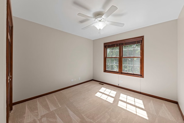 609 Spruce Ct, Oswego, IL 60543 - carpeted empty room featuring a ceiling fan and baseboards