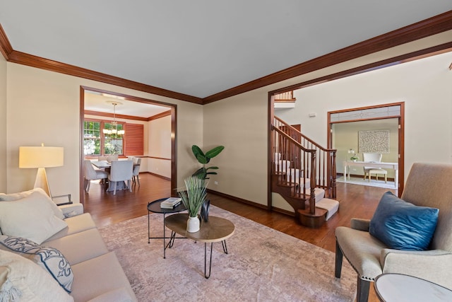 609 Spruce Ct, Oswego, IL 60543 - living area featuring wood finished floors, ornamental molding, stairs, and a chandelier