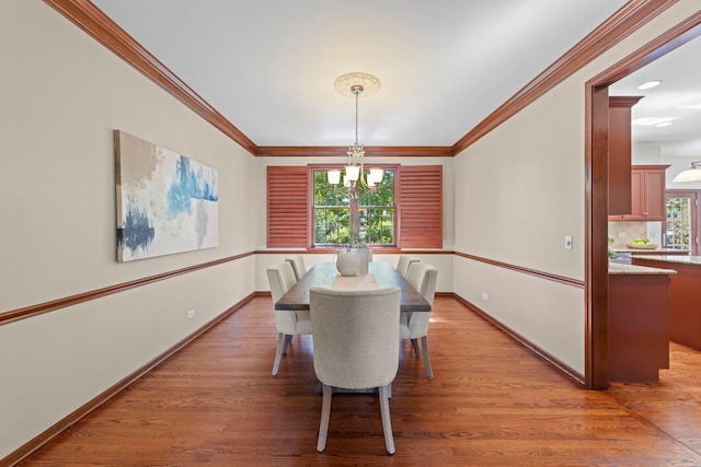 609 Spruce Ct, Oswego, IL 60543 - dining space featuring a chandelier, ornamental molding, and light wood-style floors