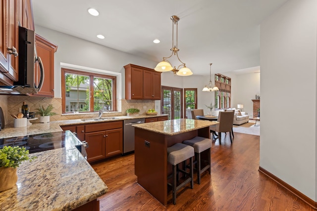 609 Spruce Ct, Oswego, IL 60543 - kitchen featuring stainless steel appliances, a center island, backsplash, recessed lighting, and dark wood finished floors