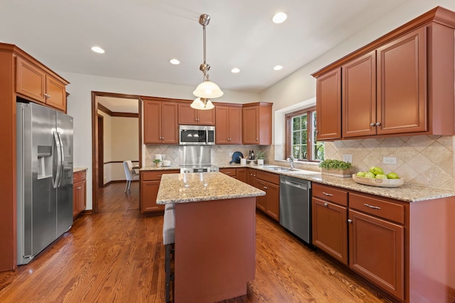 609 Spruce Ct, Oswego, IL 60543 - kitchen featuring appliances with stainless steel finishes, dark wood-type flooring, recessed lighting, tasteful backsplash, and a center island