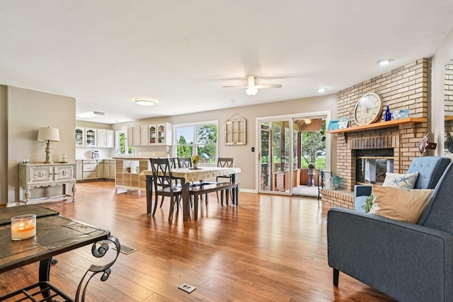 6180 Elm St, Union, IL 60180 - living room featuring a ceiling fan, light wood finished floors, and a brick fireplace