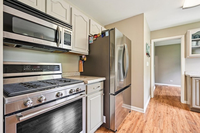 6180 Elm St, Union, IL 60180 - kitchen with stainless steel appliances, light wood-style flooring, glass insert cabinets, and white cabinets