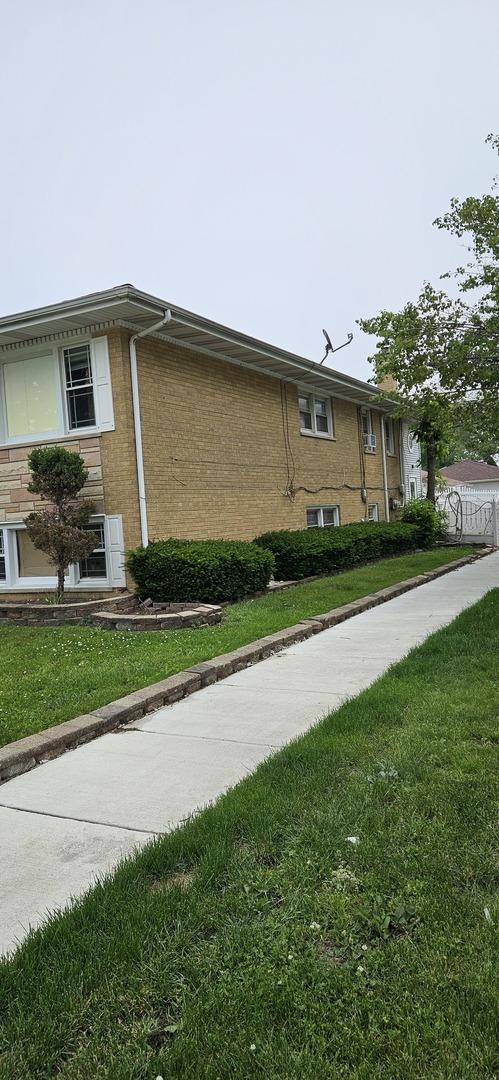 1601 44th Ave, Stone Park, IL 60165 - view of side of property with a yard and brick siding