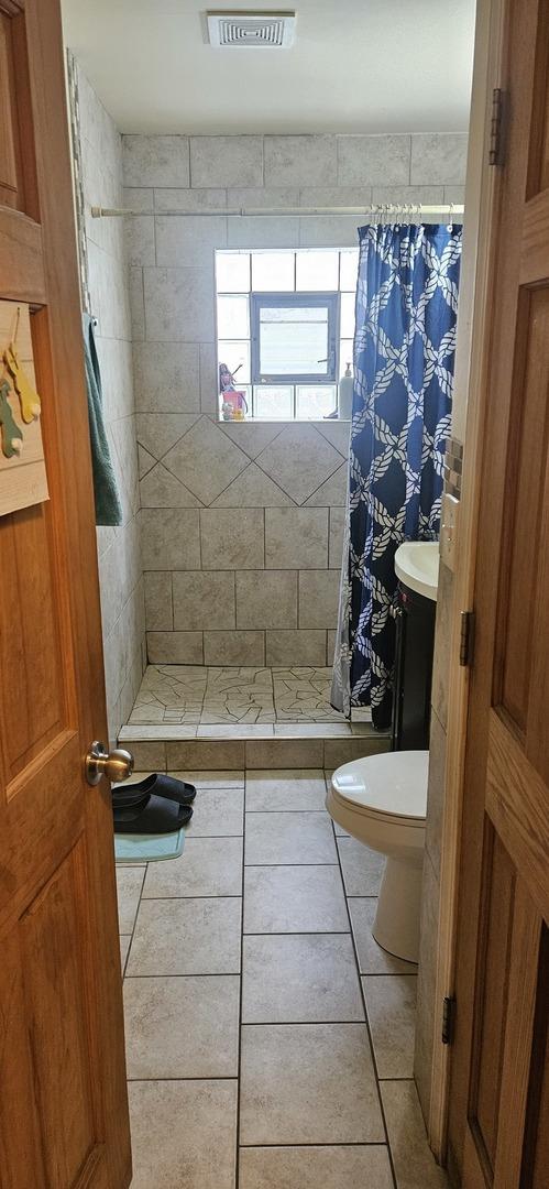 1601 44th Ave, Stone Park, IL 60165 - full bath featuring tile patterned flooring and a shower stall