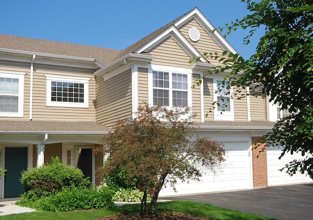 341 S Lancelot Ln, Palatine, IL 60074 - view of front of house featuring a garage, driveway, and roof with shingles