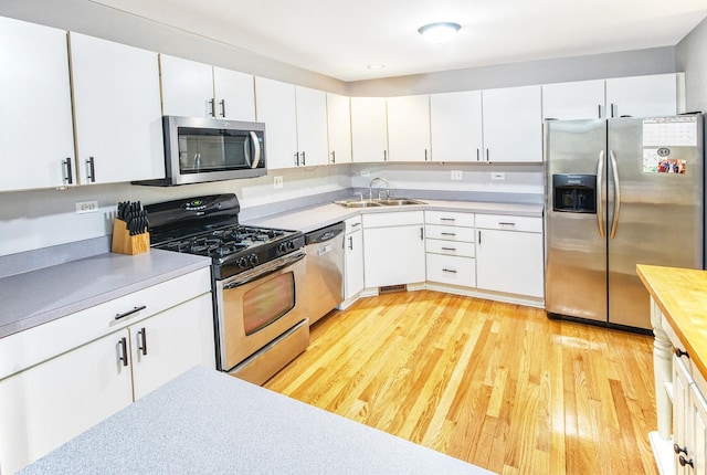 341 S Lancelot Ln, Palatine, IL 60074 - kitchen with stainless steel appliances, light wood-style flooring, and white cabinetry