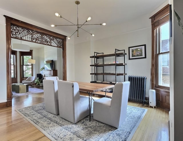 2680 N Burling St Unit 3S, Chicago, IL 60614 - dining space featuring radiator heating unit, plenty of natural light, and a chandelier