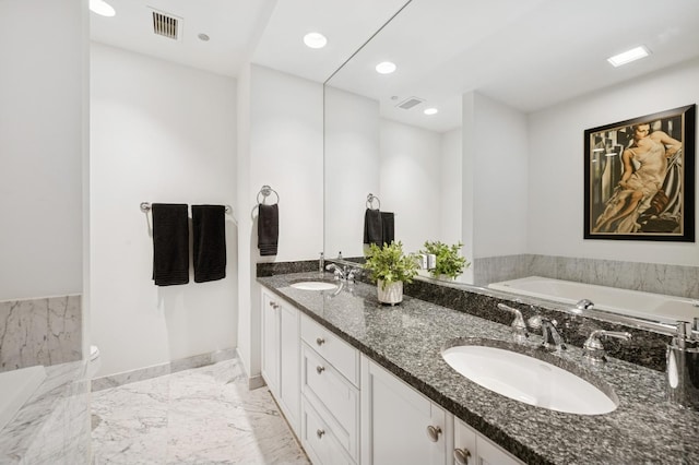 415 E N Water St Unit 806, Chicago, IL 60611 - bathroom featuring a bath, double vanity, marble finish flooring, and recessed lighting