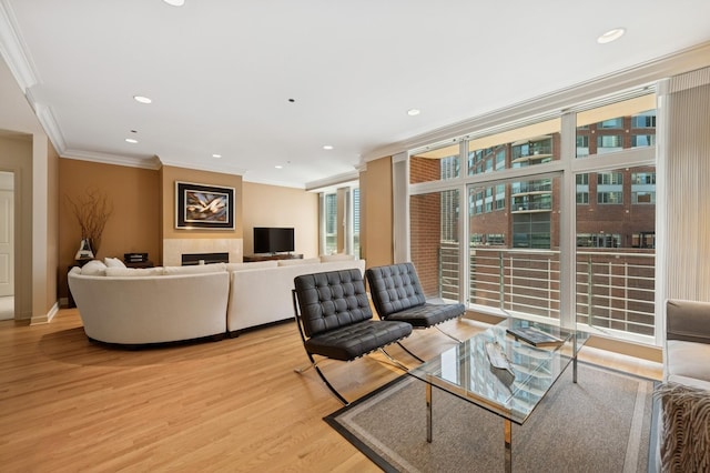 415 E N Water St Unit 806, Chicago, IL 60611 - living area with light wood-style floors, crown molding, a wall of windows, a tiled fireplace, and recessed lighting