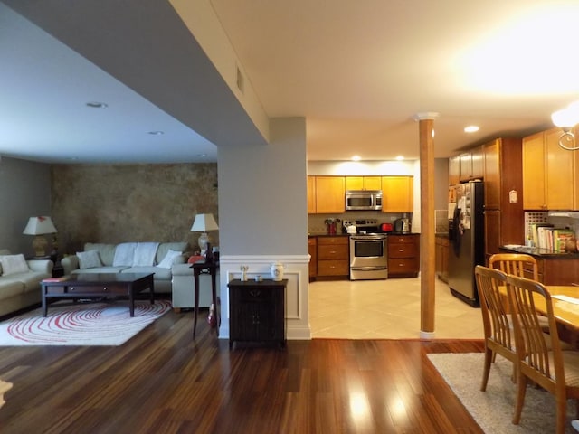 1025 S Fernandez Ave Unit 3M, Arlington Heights, IL 60005 - living area featuring ornate columns, light wood-style floors, recessed lighting, and a wainscoted wall