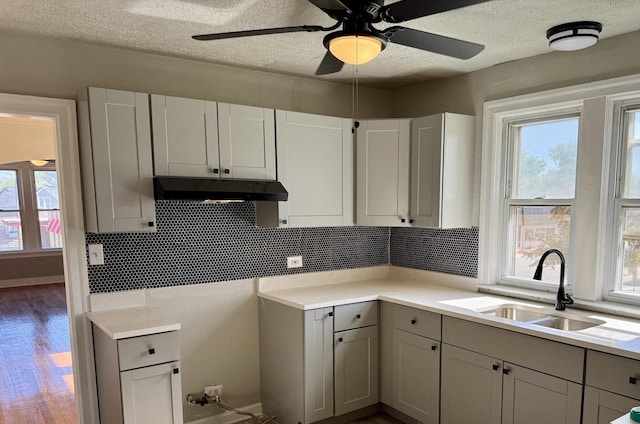 1827 170th St, Hazel Crest, IL 60429 - kitchen with under cabinet range hood, gray cabinetry, healthy amount of natural light, and a textured ceiling