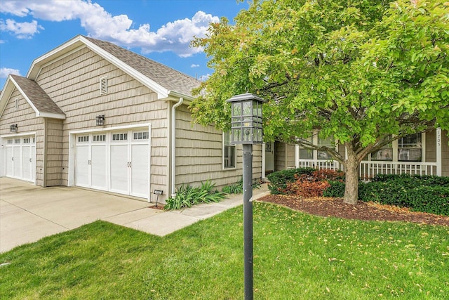 1707 Lydia Ct, Urbana, IL 61802 - view of front facade with a front yard, a garage, concrete driveway, and roof with shingles