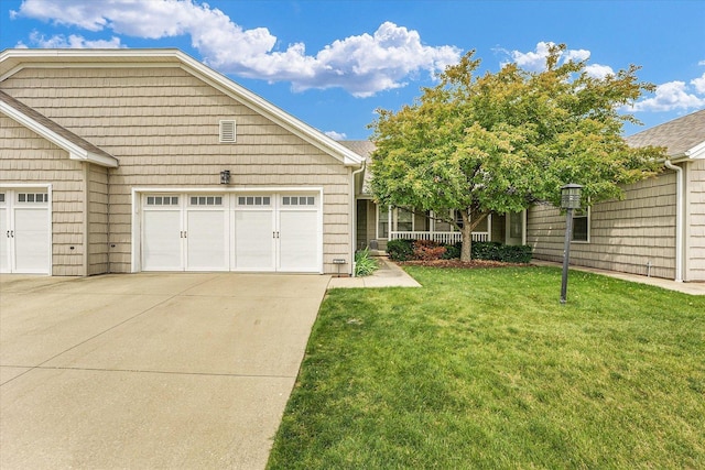 1707 Lydia Ct, Urbana, IL 61802 - view of front facade featuring a front lawn, concrete driveway, and a garage