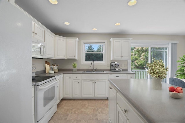 1707 Lydia Ct, Urbana, IL 61802 - kitchen with white appliances, white cabinetry, recessed lighting, and stone finish flooring