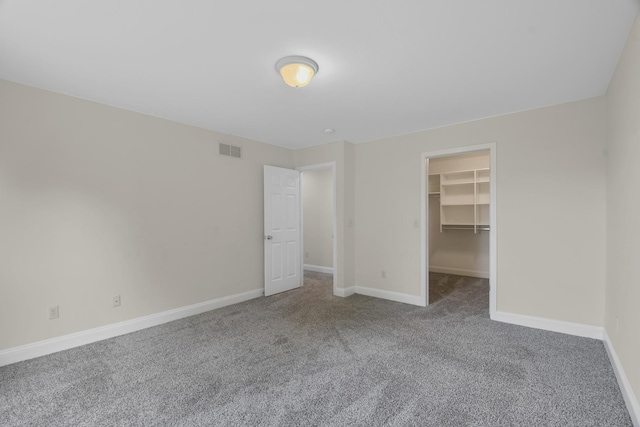 1707 Lydia Ct, Urbana, IL 61802 - unfurnished bedroom with carpet flooring, a walk in closet, and a closet