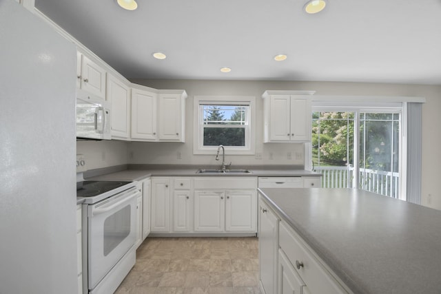 1707 Lydia Ct, Urbana, IL 61802 - kitchen with white appliances, healthy amount of natural light, white cabinets, and recessed lighting