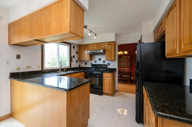 4085 N New Britton Dr, Hoffman Estates, IL 60192 - kitchen with black appliances, under cabinet range hood, a peninsula, and dark stone countertops