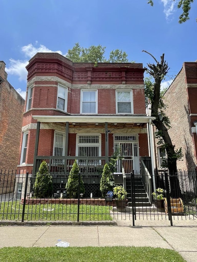 5632 S Peoria St, Chicago, IL 60621 - view of property with a porch, brick siding, and a fenced front yard