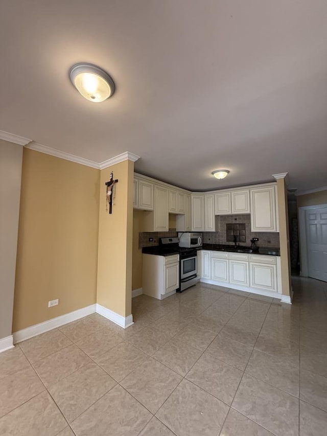5632 S Peoria St, Chicago, IL 60621 - kitchen with stainless steel appliances, crown molding, dark countertops, tasteful backsplash, and light tile patterned flooring