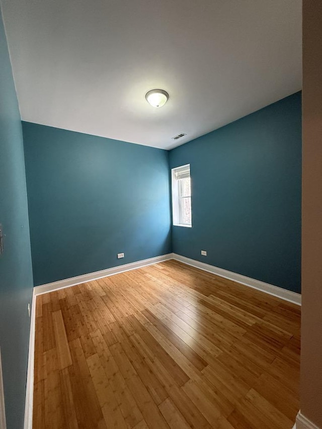 5632 S Peoria St, Chicago, IL 60621 - empty room with wood-type flooring and baseboards