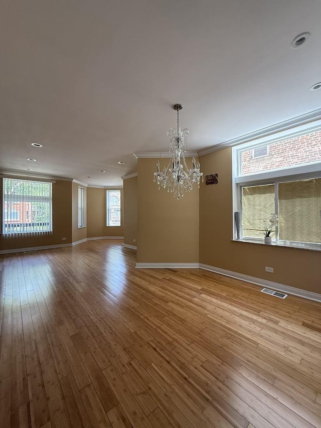 5632 S Peoria St, Chicago, IL 60621 - spare room featuring crown molding, a chandelier, wood finished floors, and recessed lighting