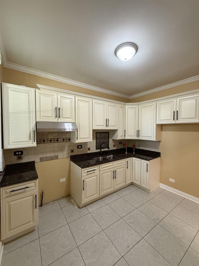 5632 S Peoria St, Chicago, IL 60621 - kitchen featuring ornamental molding, under cabinet range hood, light tile patterned flooring, and tasteful backsplash