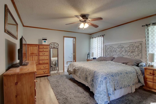701 Dudley St, Liberty, IL 62347 - bedroom featuring light wood-style flooring, a textured ceiling, crown molding, multiple windows, and a ceiling fan