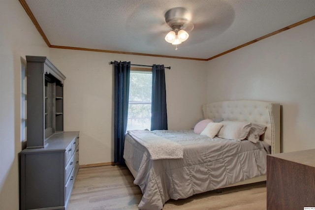 701 Dudley St, Liberty, IL 62347 - bedroom with ornamental molding, light wood-style floors, a textured ceiling, and ceiling fan