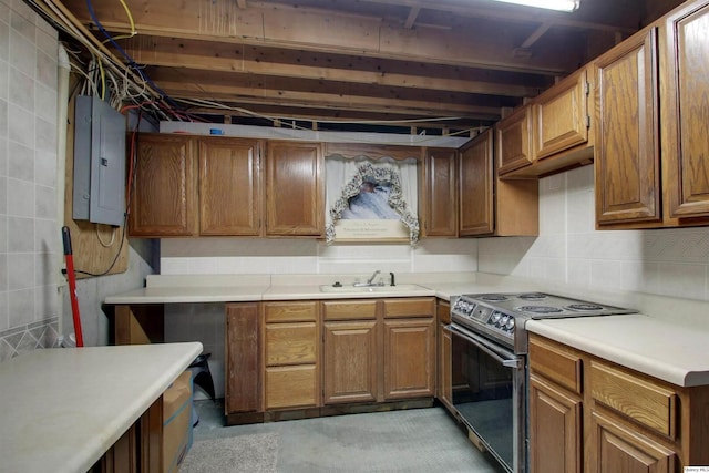 701 Dudley St, Liberty, IL 62347 - kitchen featuring range with electric stovetop, electric panel, light countertops, and brown cabinetry