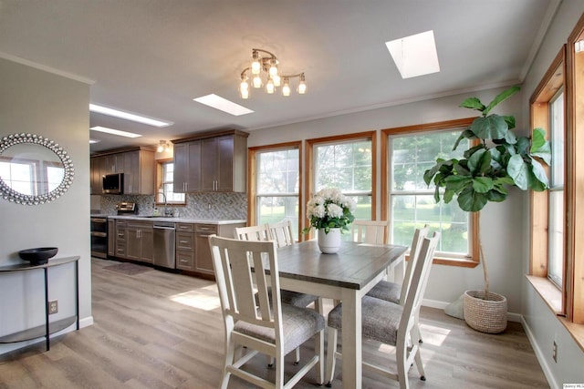 701 Dudley St, Liberty, IL 62347 - dining space with a skylight, light wood-style flooring, and ornamental molding
