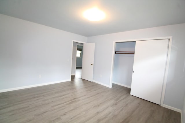9682 Orr Ln, Winnebago, IL 61088 - unfurnished bedroom featuring wood finished floors and a closet