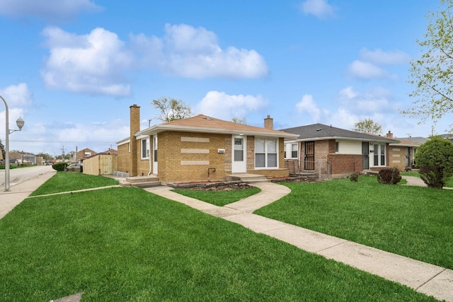 9401 S Sangamon St, Chicago, IL 60620 - view of front of house with a chimney, brick siding, and a front yard