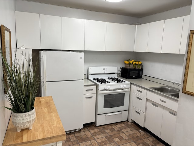 1450 E 55th Pl Unit 927S, Chicago, IL 60615 - kitchen featuring white appliances, white cabinets, light countertops, and brick patterned floors