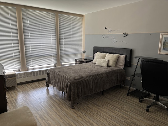 1450 E 55th Pl Unit 927S, Chicago, IL 60615 - bedroom with radiator heating unit and wood finished floors