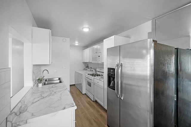 7927 164th Pl Unit 236, Tinley Park, IL 60477 - kitchen with white appliances, wood finished floors, light countertops, white cabinets, and decorative backsplash