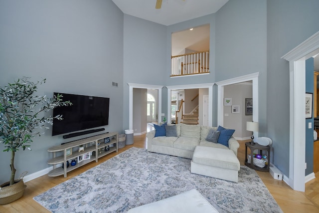 624 Pottawatomie Trl, Batavia, IL 60510 - living room featuring stairs, a towering ceiling, a ceiling fan, and wood finished floors