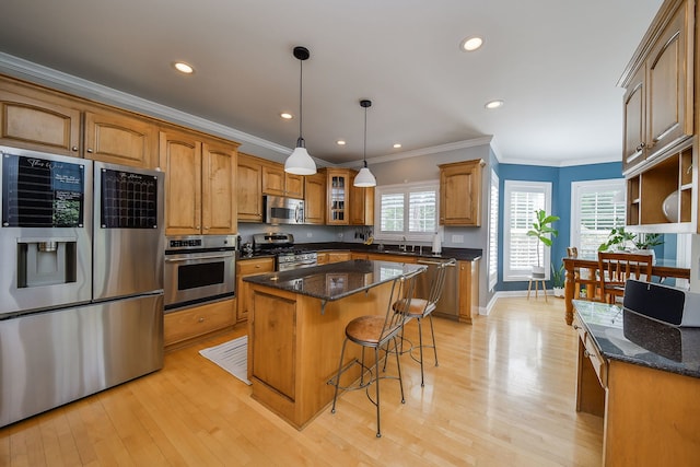 624 Pottawatomie Trl, Batavia, IL 60510 - kitchen featuring appliances with stainless steel finishes, ornamental molding, brown cabinets, light wood-style flooring, and a center island