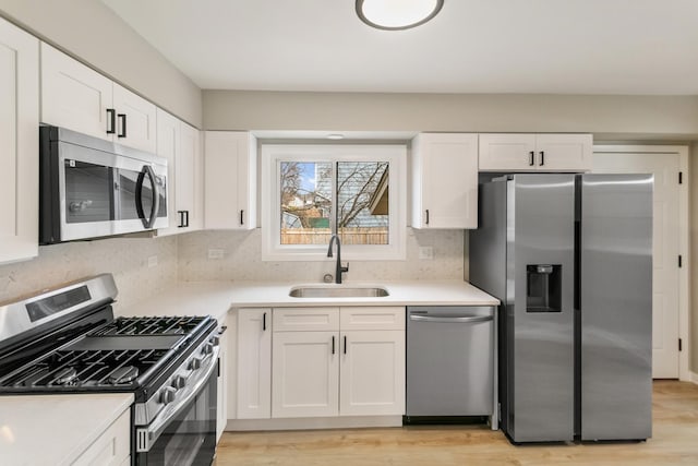 326 W Hawthorne Blvd, Mundelein, IL 60060 - kitchen with stainless steel appliances, white cabinetry, backsplash, and light countertops