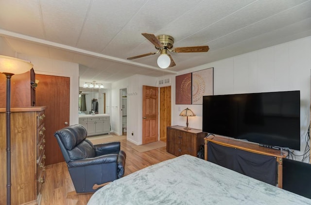 449 W 6th St, Braidwood, IL 60408 - bedroom with light wood finished floors, connected bathroom, and a ceiling fan