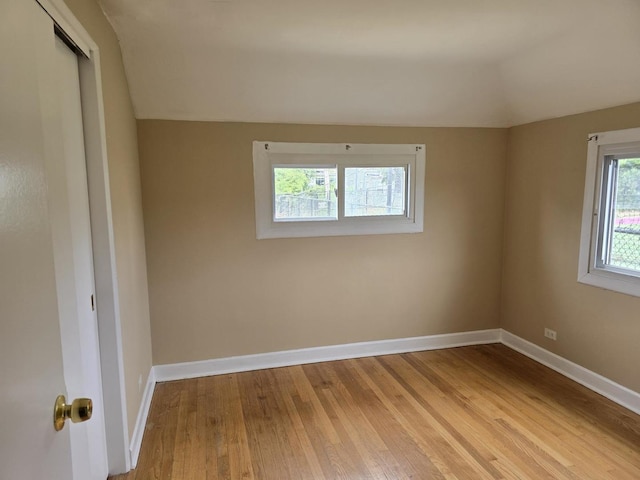 2130 W Highland Ave, Chicago, IL 60659 - spare room featuring hardwood / wood-style flooring and vaulted ceiling