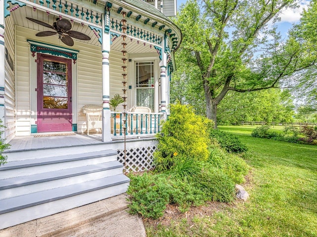 466 Quail Trap Rd, Caledonia, IL 61011 - entrance to property with covered porch, a ceiling fan, and a lawn